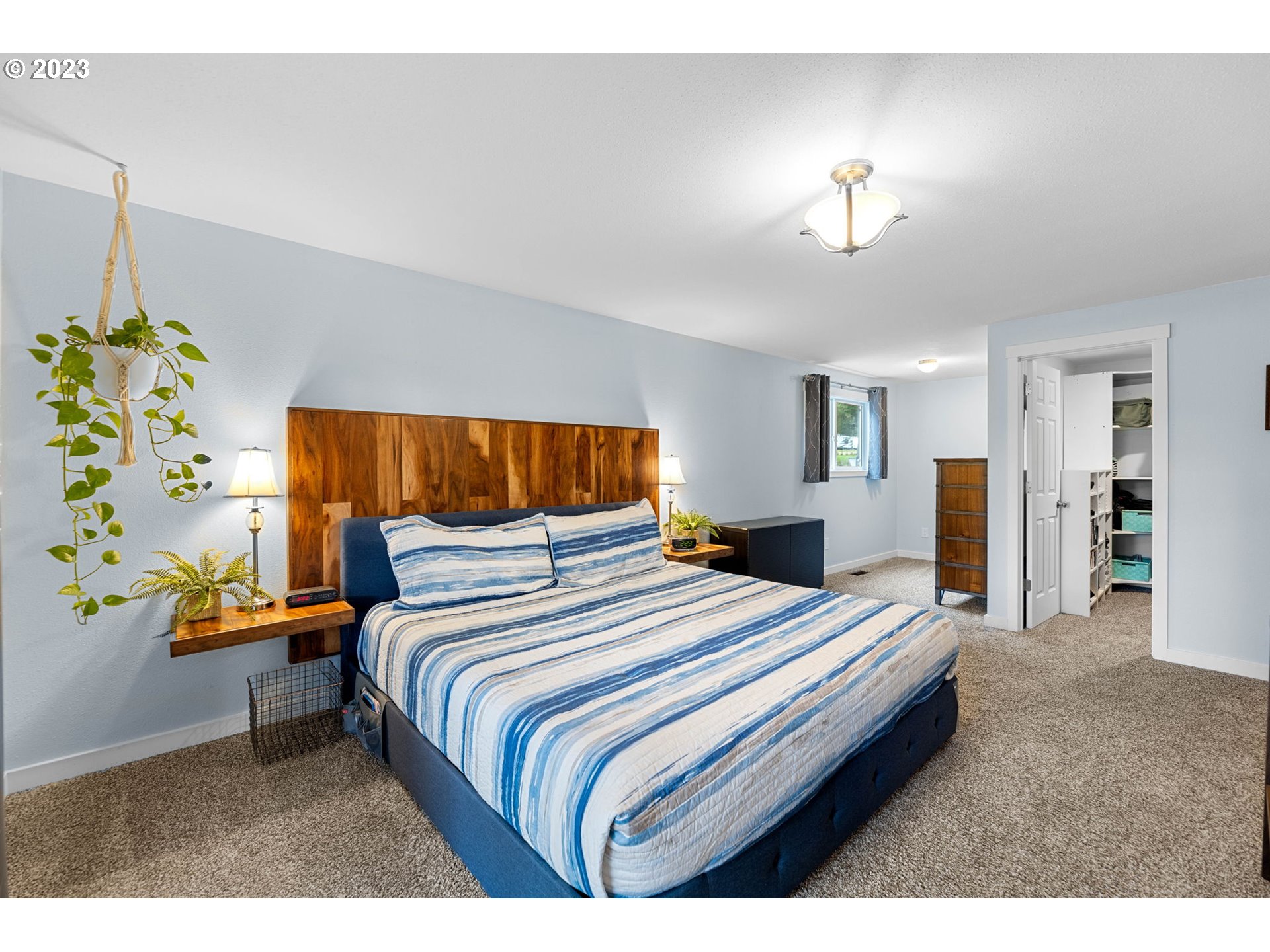 4412 Northeast 292nd Avenue Camas, WA 98607 - Photo 15 of 48 a bedroom with a bed and a chandelier