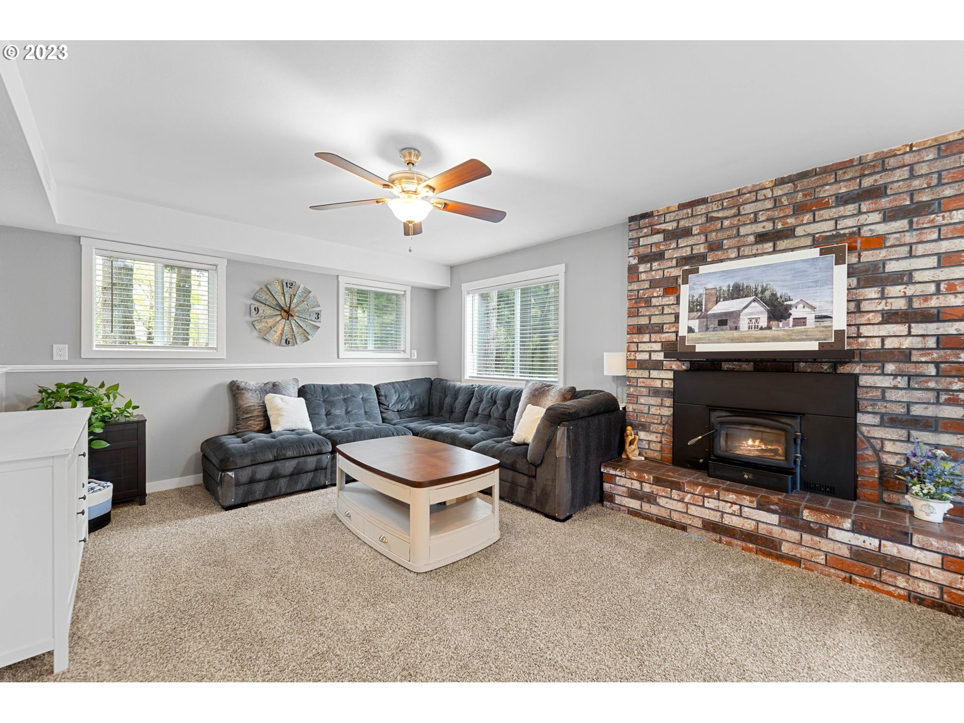 4412 Northeast 292nd Avenue Camas, WA 98607 - Photo 26 of 48 a living room with furniture a fireplace and a flat screen tv