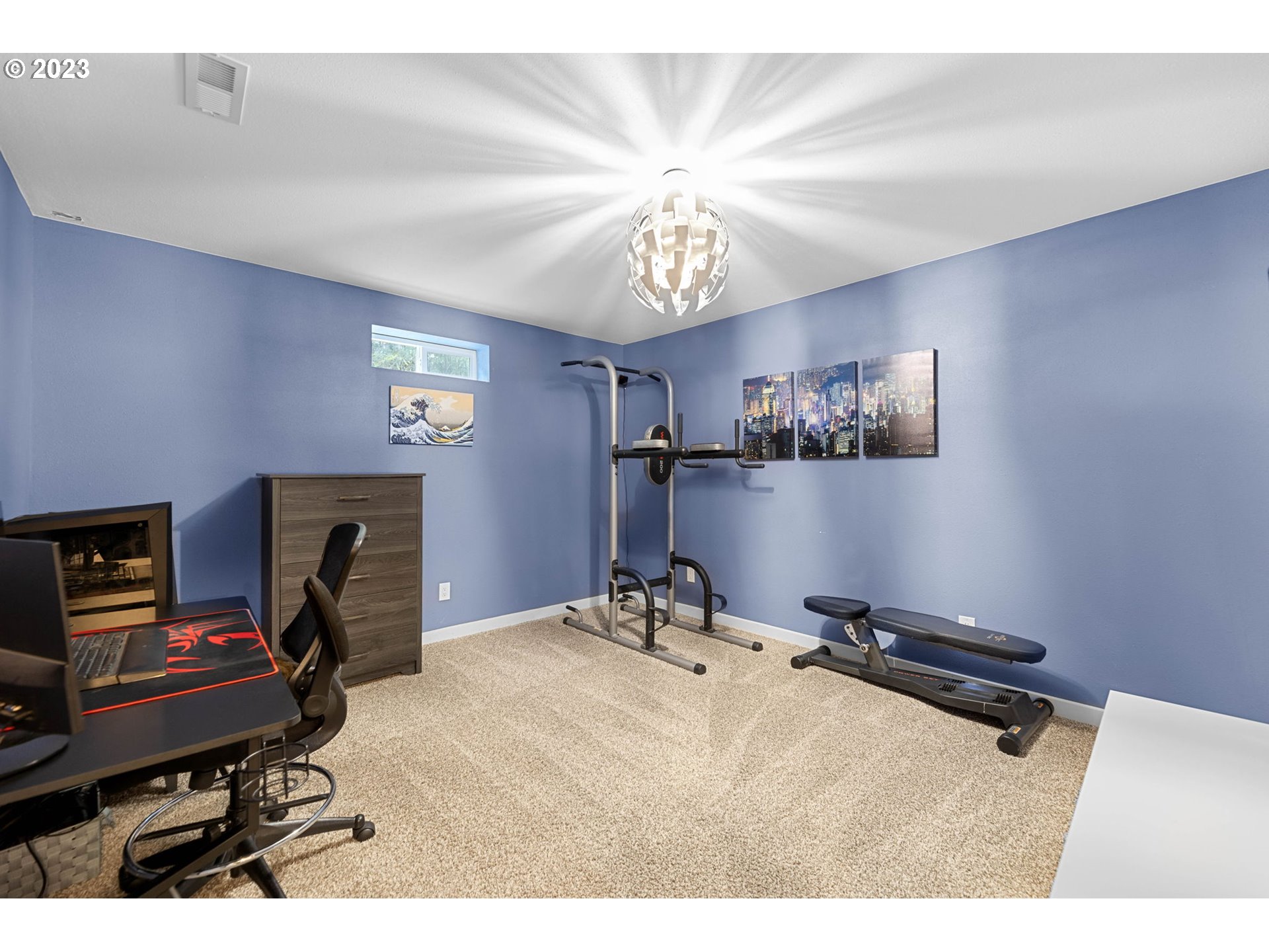 4412 Northeast 292nd Avenue Camas, WA 98607 - Photo 31 of 48 a room with gym equipment and a chandelier