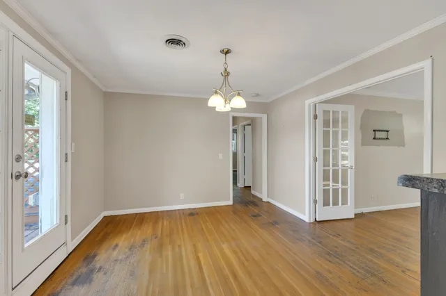 a view of a room with wooden floor staircase and a living room