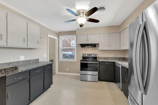 a kitchen with stainless steel appliances granite countertop a sink stove and refrigerator