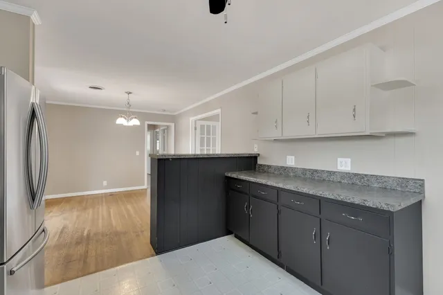 a kitchen with stainless steel appliances granite countertop a refrigerator and a sink