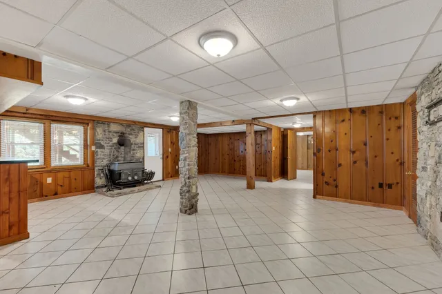 a room with furniture pool table and windows