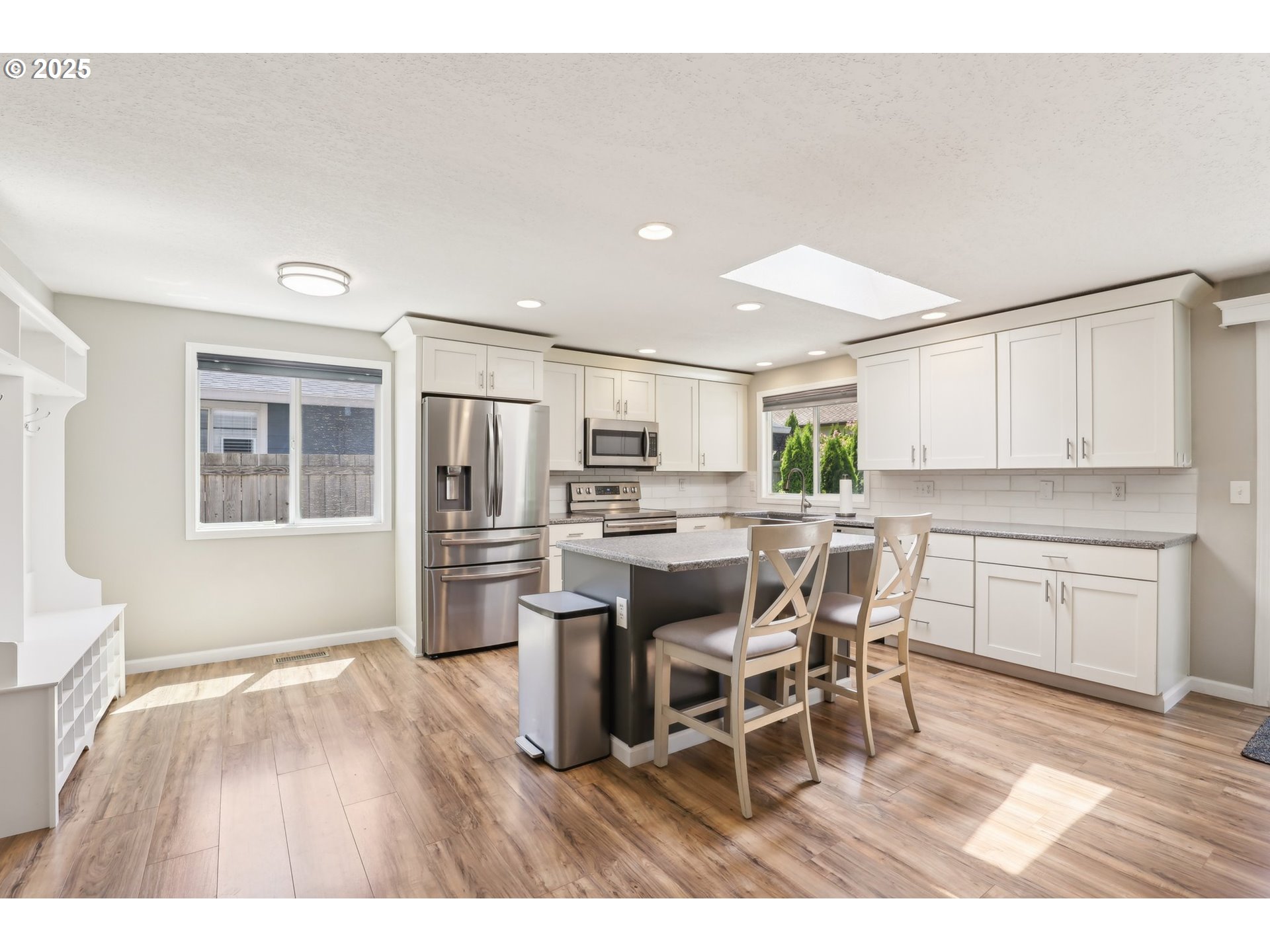 29495 Southwest Yosemite Street Wilsonville, OR 97070 - Photo 13 of 40 a kitchen with stainless steel appliances kitchen island granite countertop a dining table chairs and granite counter tops