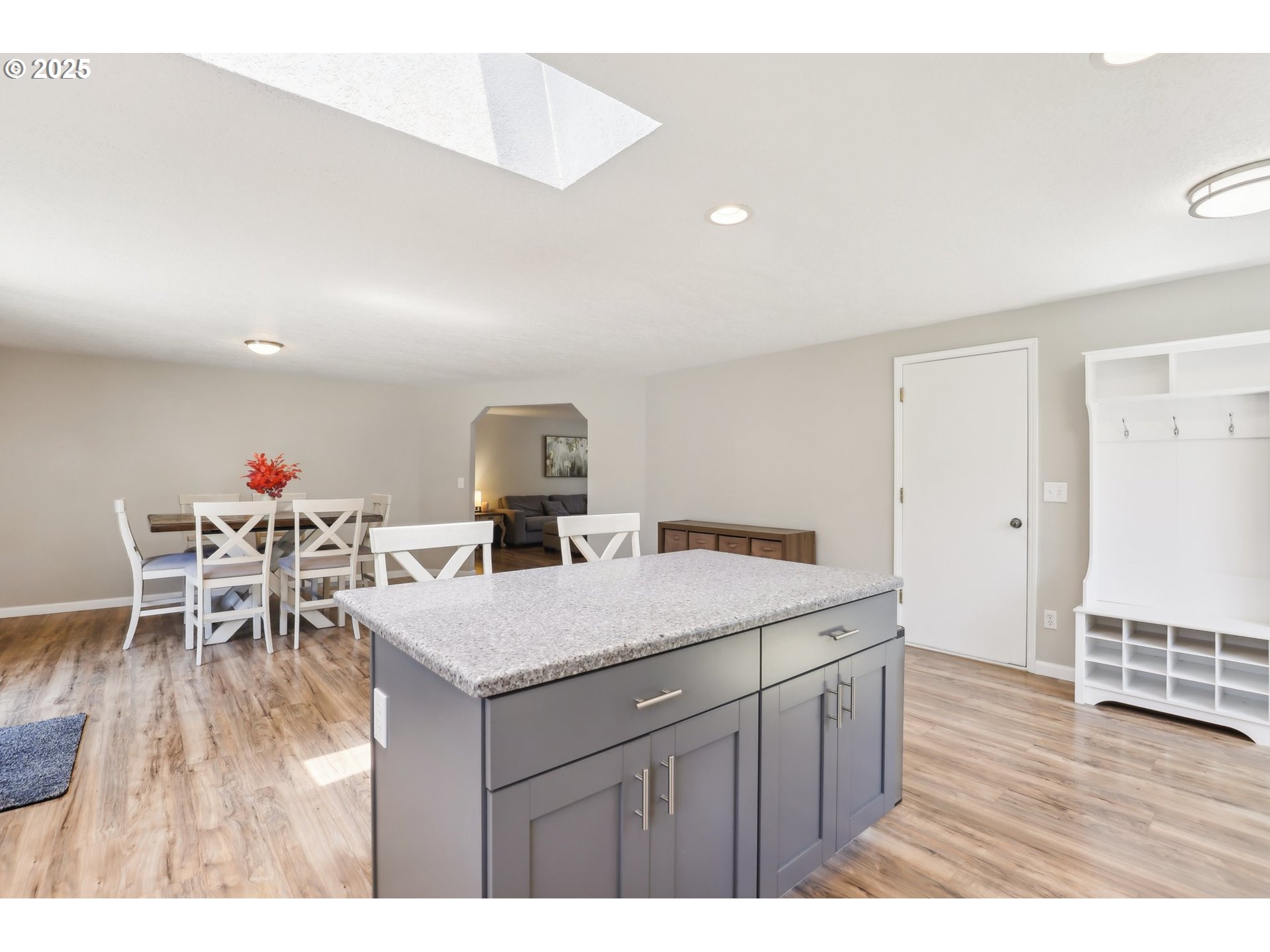 29495 Southwest Yosemite Street Wilsonville, OR 97070 - Photo 14 of 40 a kitchen with a dining table chairs and white cabinets