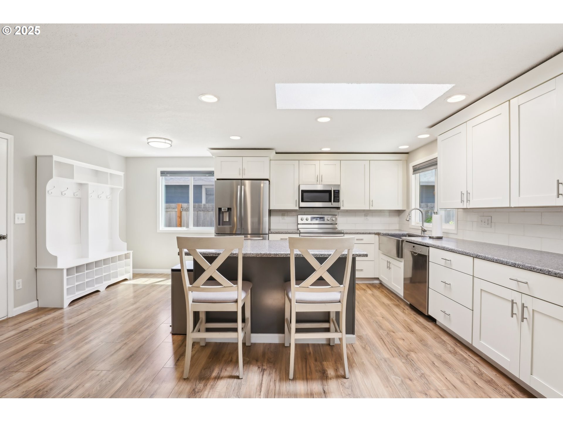 29495 Southwest Yosemite Street Wilsonville, OR 97070 - Photo 15 of 40 a open kitchen with stainless steel appliances kitchen island granite countertop a dining table chairs and view living room