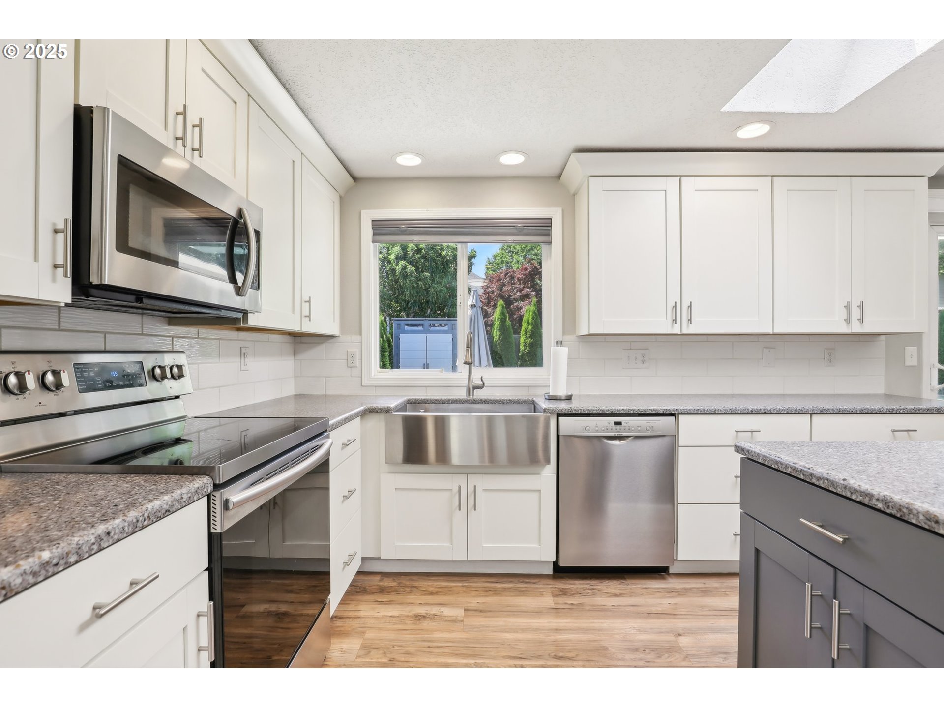29495 Southwest Yosemite Street Wilsonville, OR 97070 - Photo 19 of 40 a kitchen with stainless steel appliances granite countertop a stove a sink and a microwave