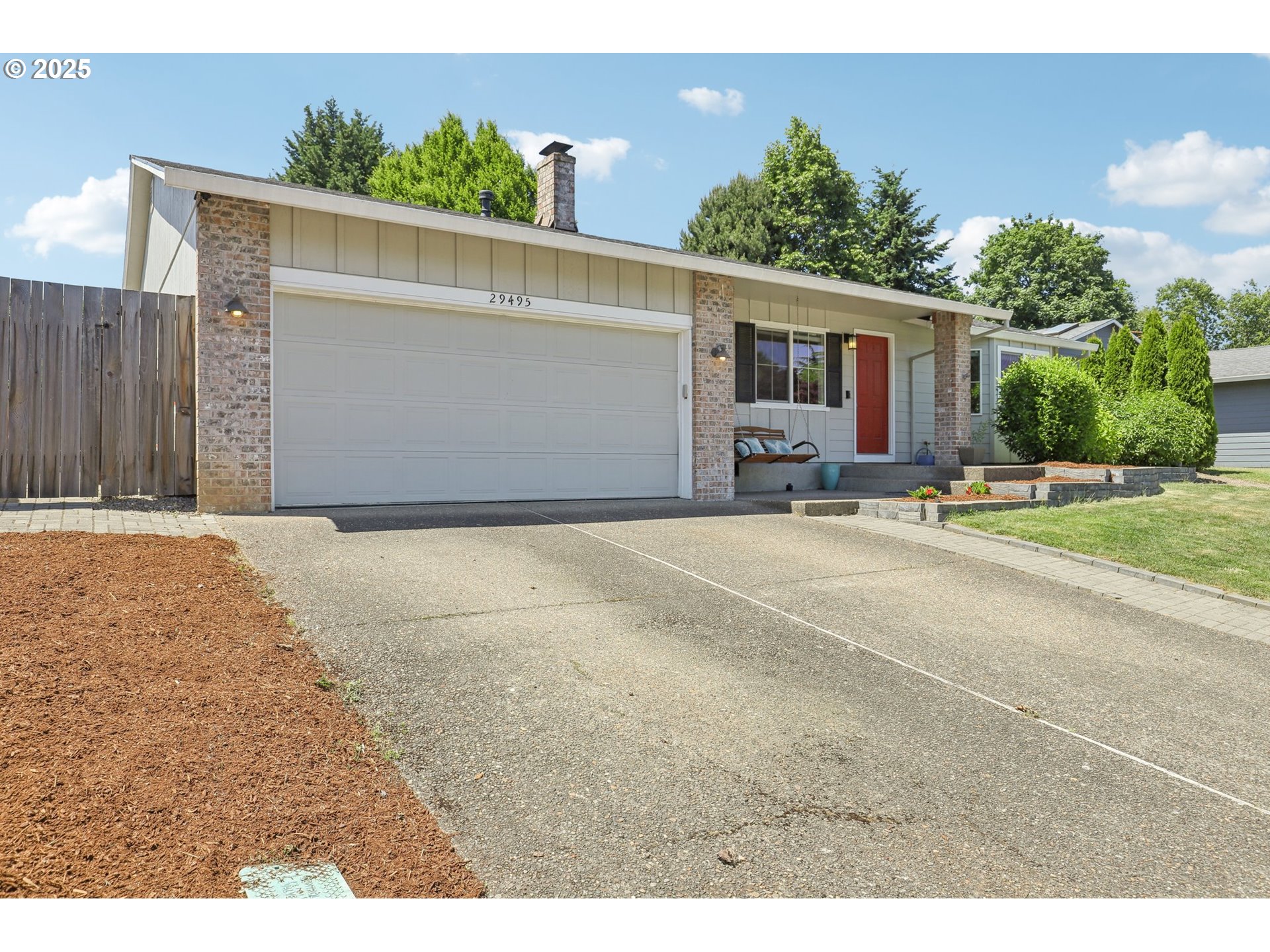 29495 Southwest Yosemite Street Wilsonville, OR 97070 - Photo 2 of 40 a backyard of a house with table and chairs