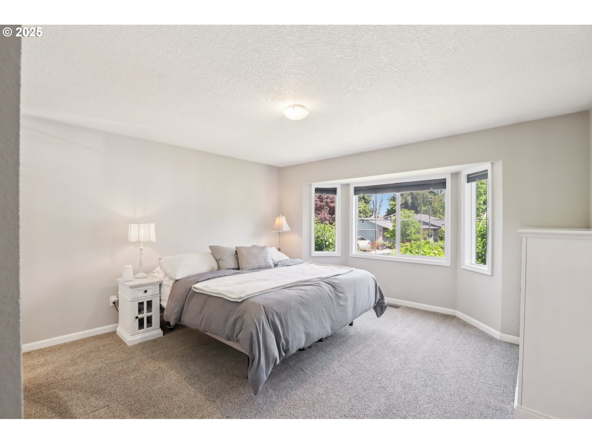 29495 Southwest Yosemite Street Wilsonville, OR 97070 - Photo 26 of 40 a bedroom with a bed and a large window