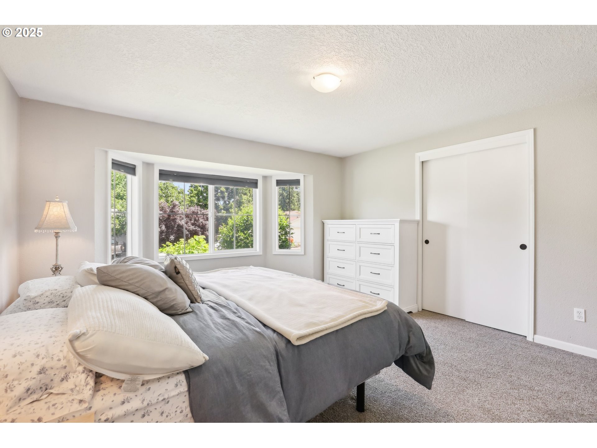 29495 Southwest Yosemite Street Wilsonville, OR 97070 - Photo 28 of 40 a bedroom with a bed and a large window