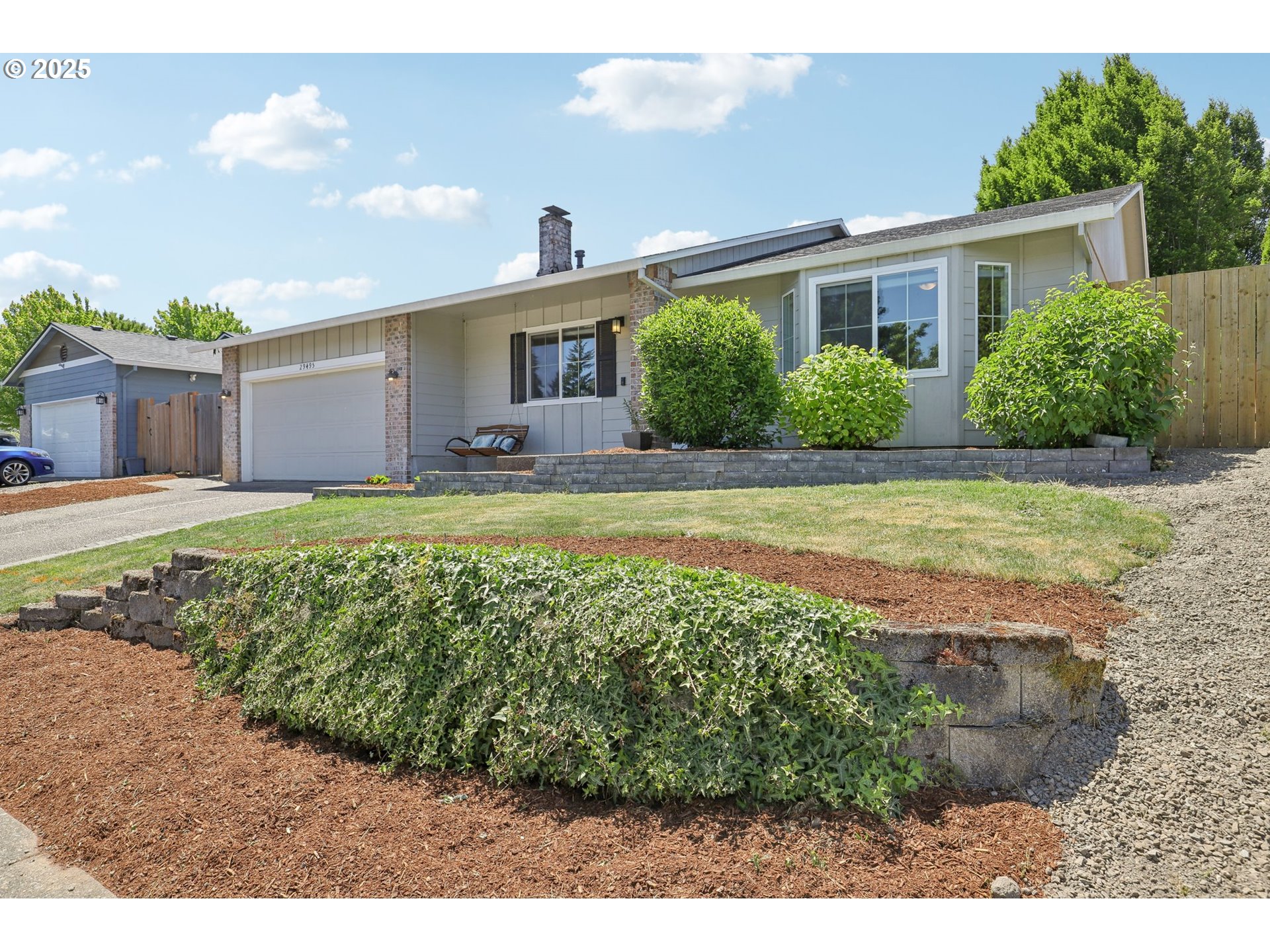 29495 Southwest Yosemite Street Wilsonville, OR 97070 - Photo 3 of 40 a view of a house with a yard and a large tree