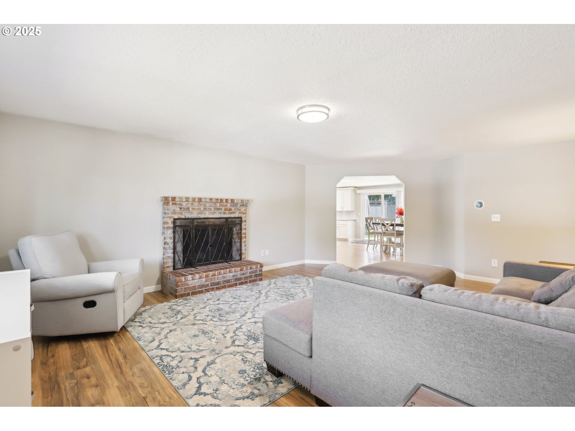 29495 Southwest Yosemite Street Wilsonville, OR 97070 - Photo 6 of 40 a living room with furniture and a fireplace