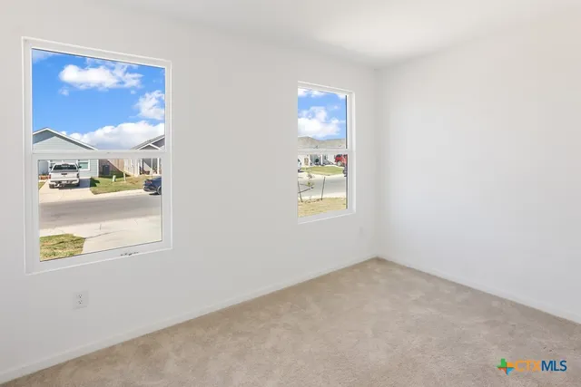 an empty room with windows and entrance
