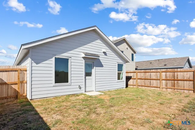 a view of a house with a backyard