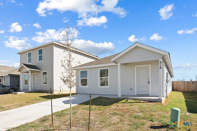 a front view of a house with a yard