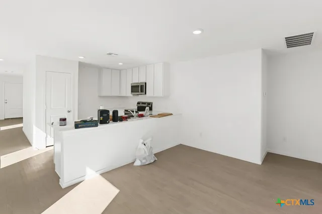 a kitchen with sink cabinets and microwave