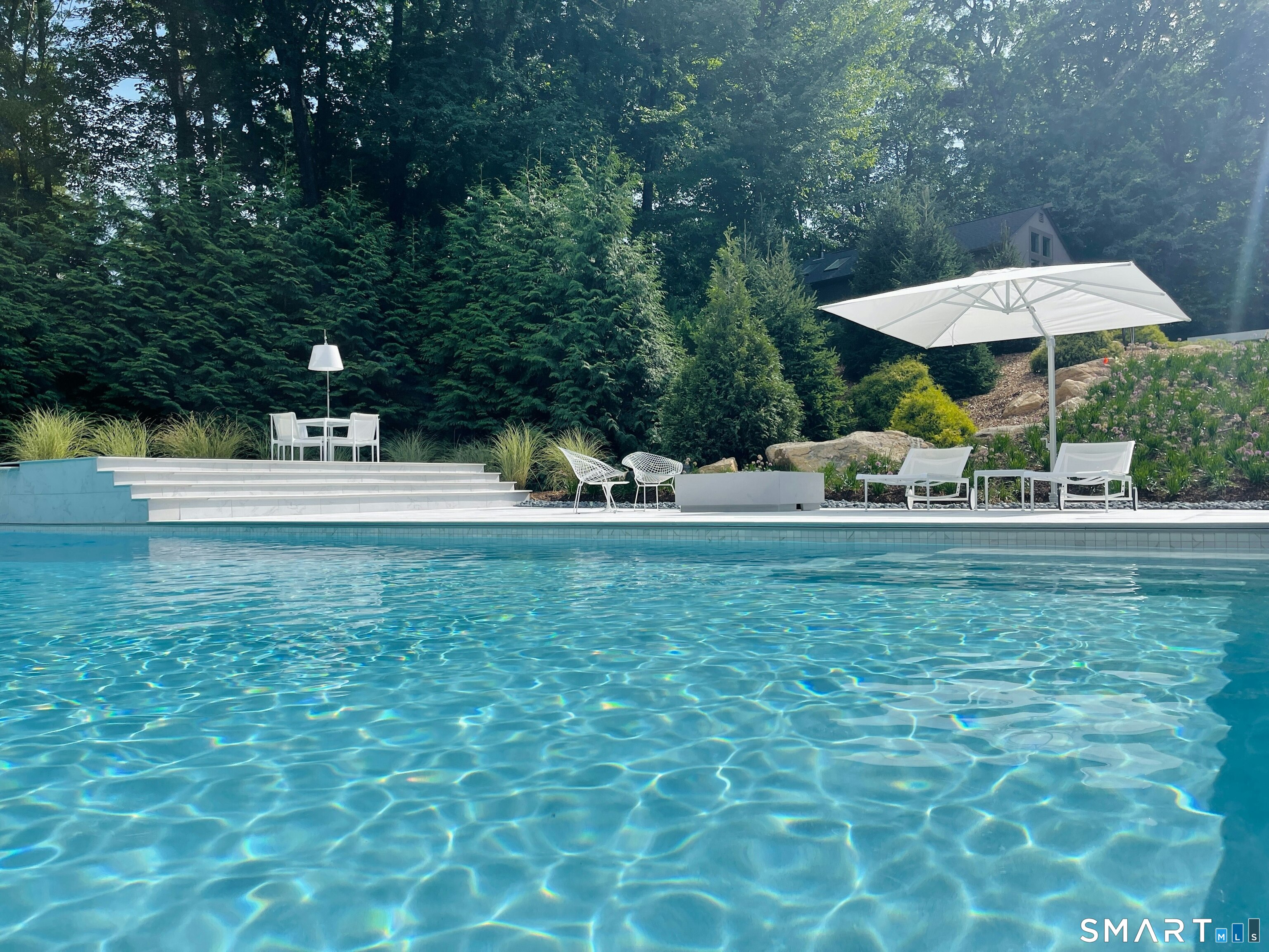 300 Sturges Ridge Road Wilton, CT 06897 - Photo 7 of 40 a backyard of a house with table and chairs