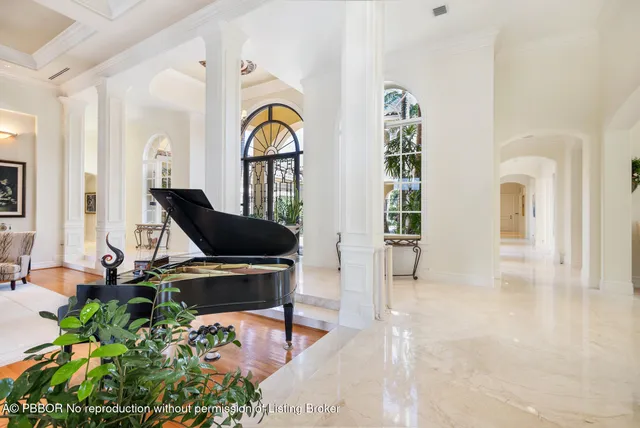 a large white kitchen with granite countertop a sink and cabinets