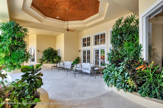 an aerial view of a house with a yard and lake view