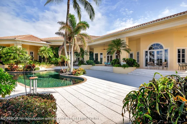 a front view of a house with a yard and a garage