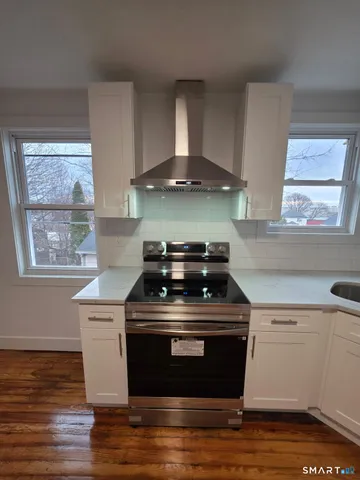 a stove top oven sitting inside of a kitchen