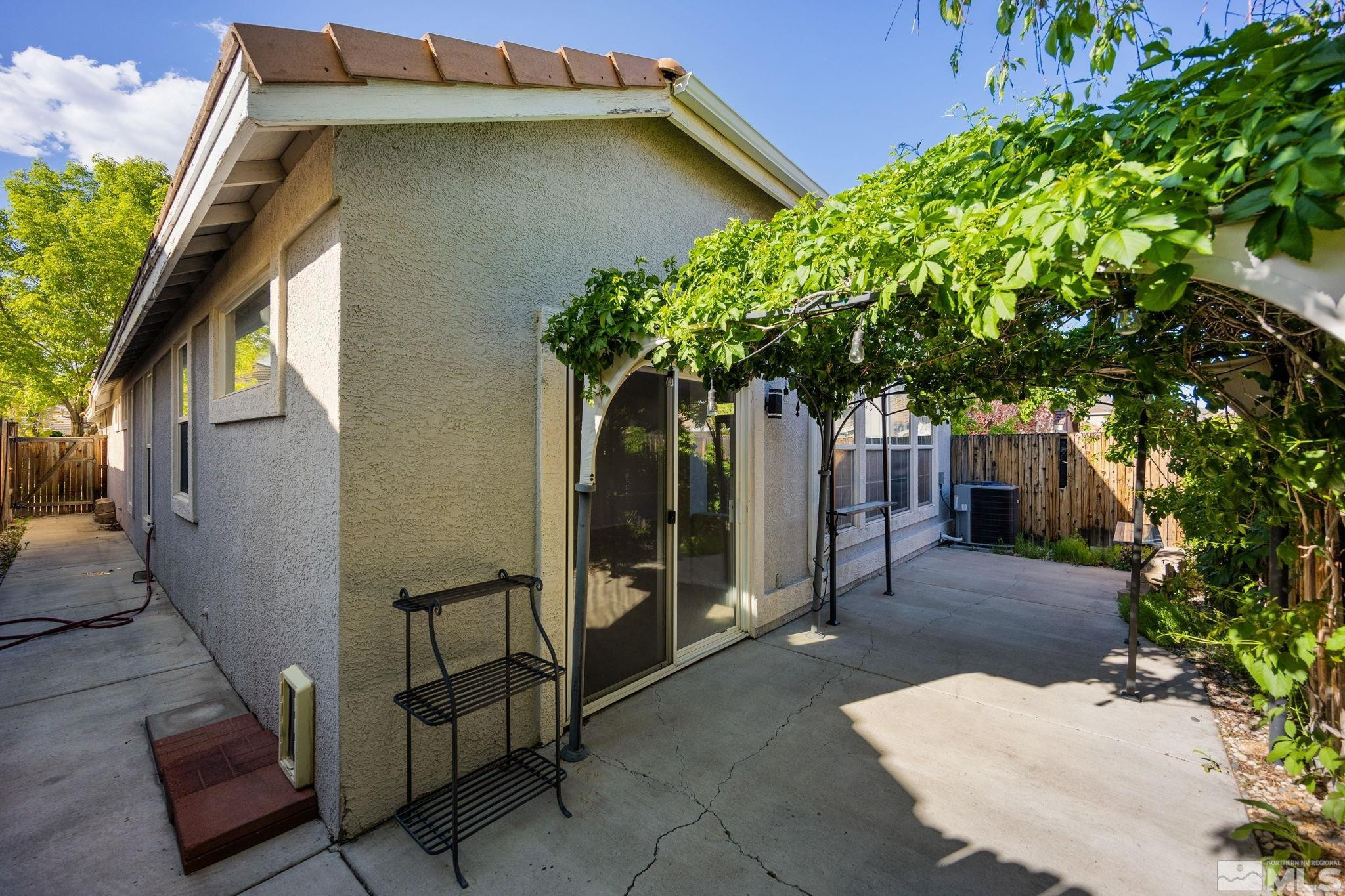 9653 Truckee Meadows Place Reno, NV 89521 - Photo 20 of 22 a backyard of a house with table and chairs and potted plants