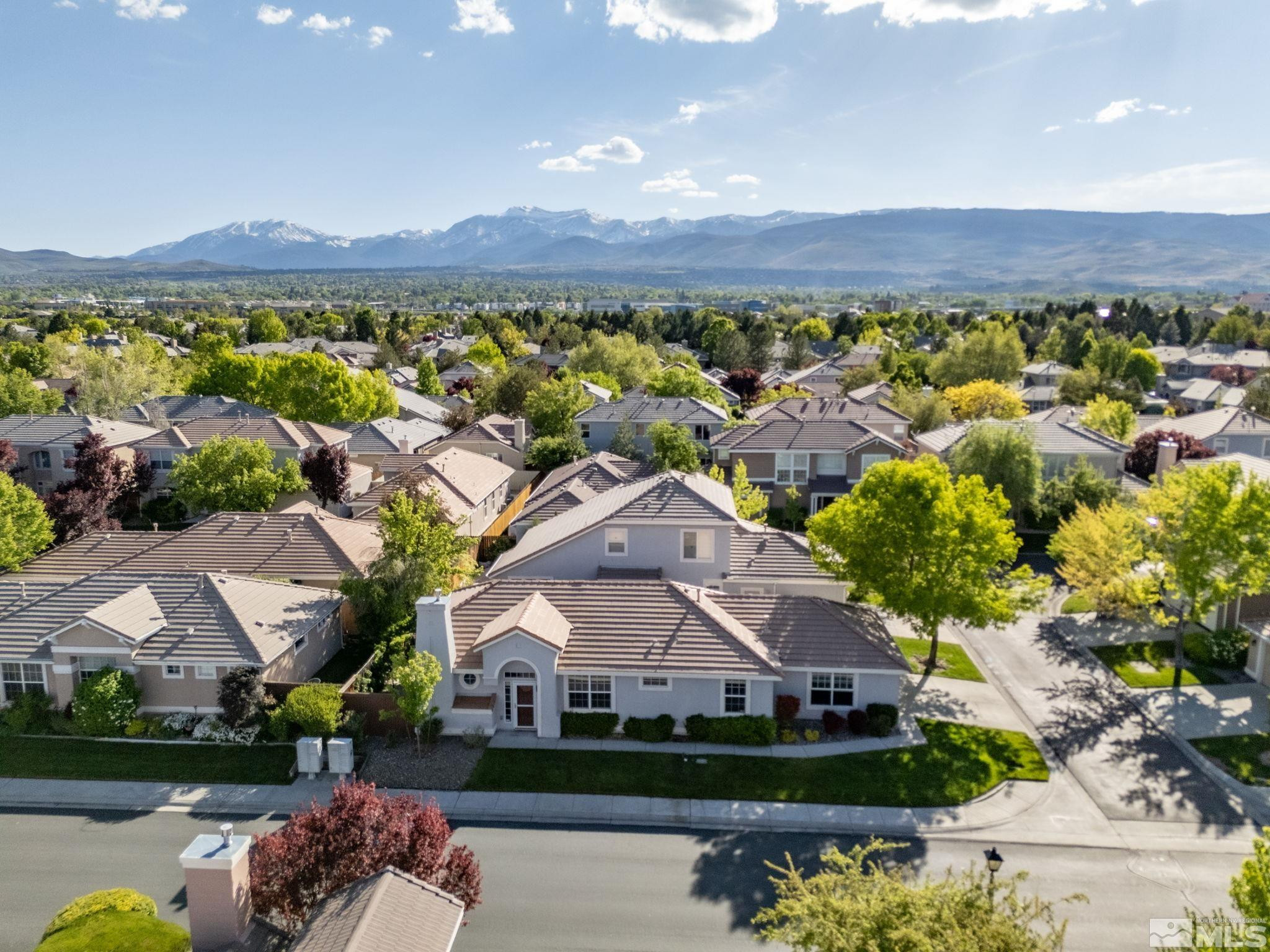 9653 Truckee Meadows Place Reno, NV 89521 - Photo 5 of 22 a view of a big house with a big yard and large trees