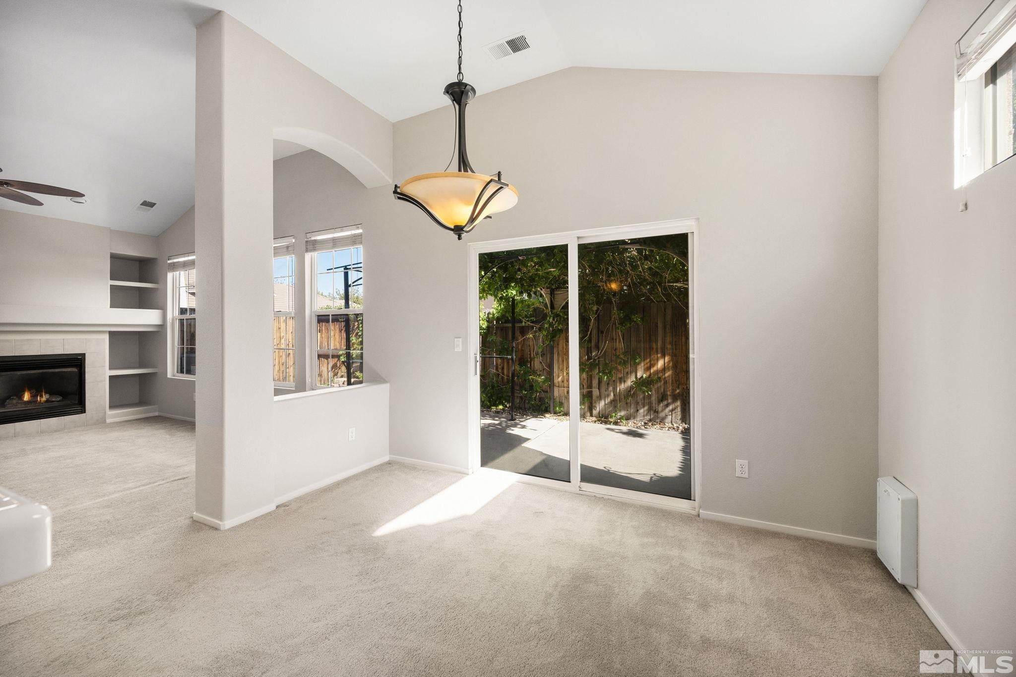9653 Truckee Meadows Place Reno, NV 89521 - Photo 7 of 22 a view of an empty room with fireplace and a window