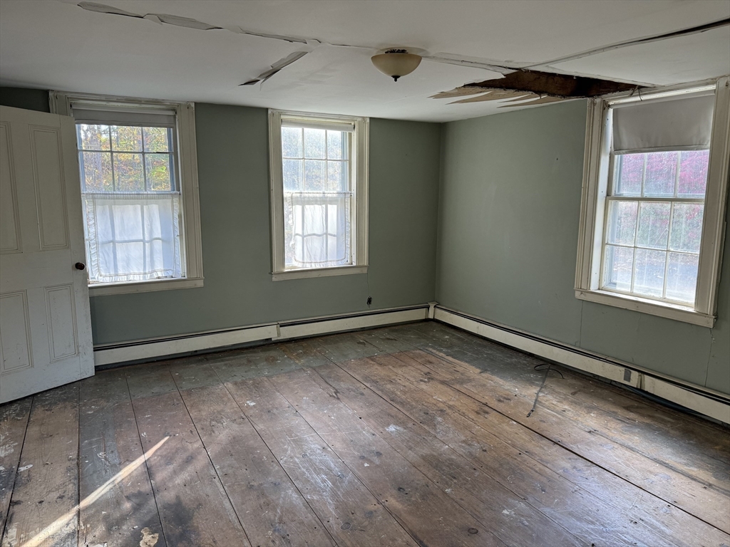56 Barre Road Oakham, MA 01068 - Photo 13 of 36 an empty room with wooden floor and windows