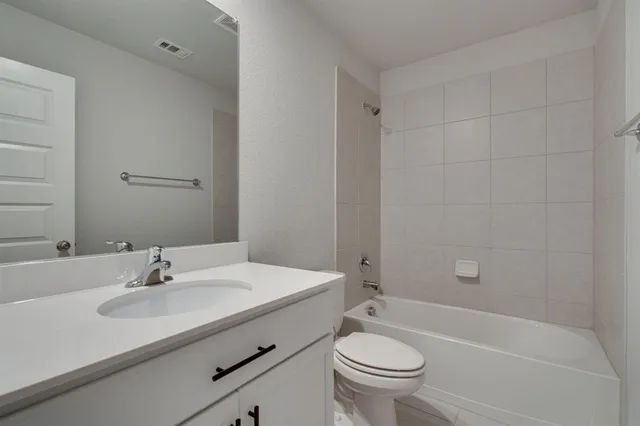 a bathroom with a sink toilet a mirror and shower