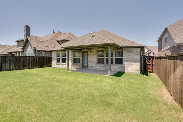 a view of a house with backyard porch and wooden fence