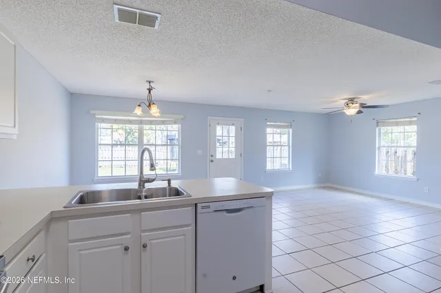 a kitchen with granite countertop a sink cabinets and window