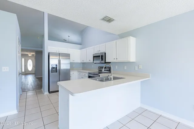 a kitchen with stainless steel appliances a sink stove and refrigerator