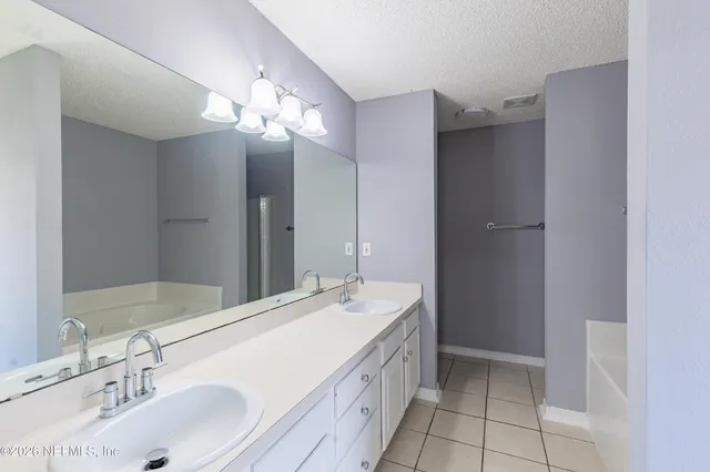 a bathroom with a sink a vanity and a mirror