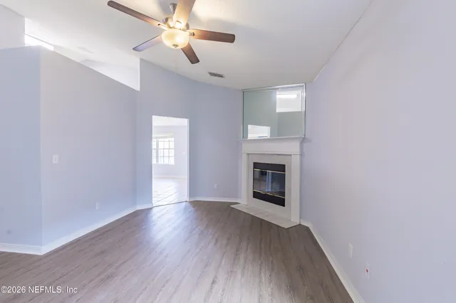 wooden floor in an empty room with a fireplace