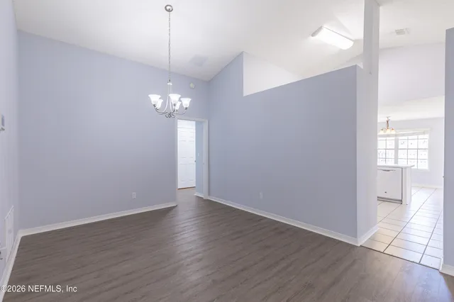 a view of a room with wooden floor and windows