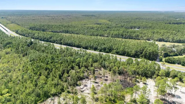 a view of a green field with an ocean view