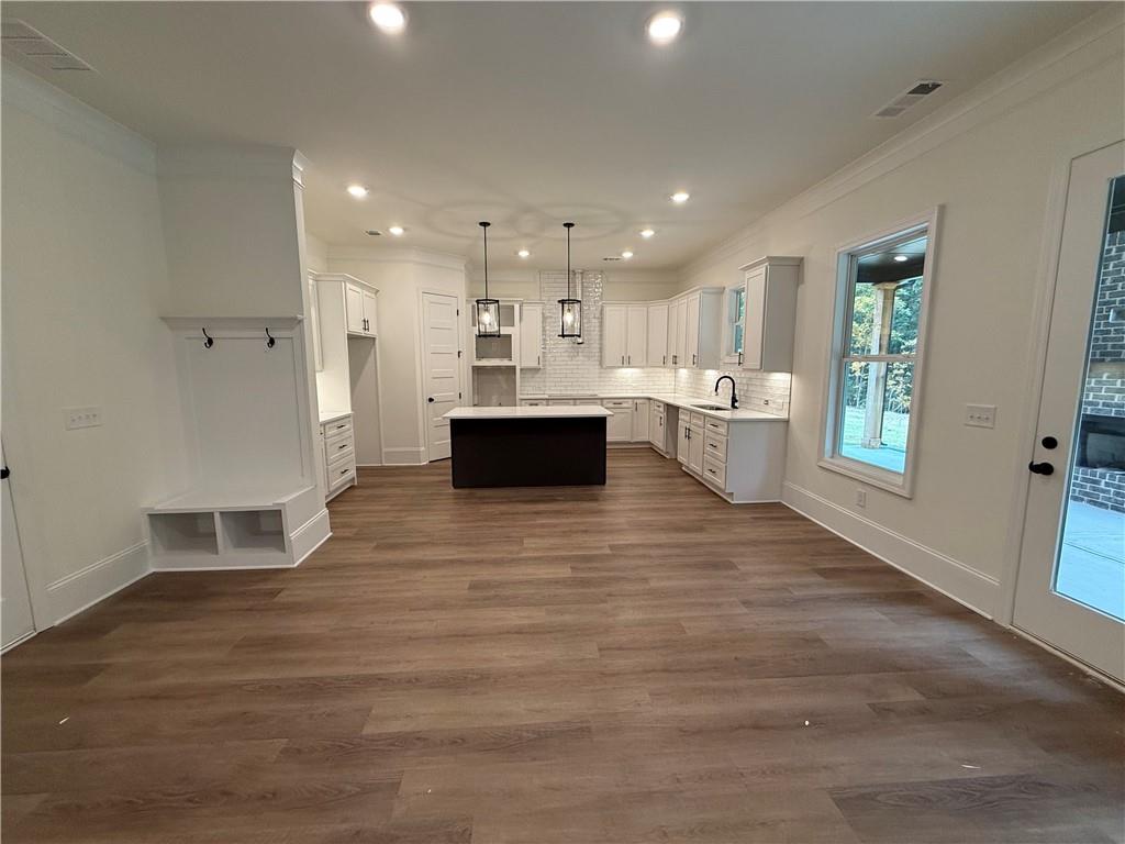 3229 Traditions Way Jefferson, GA 30549 - Photo 13 of 43 a view of kitchen with stainless steel appliances kitchen island hardwood floor sink stove and granite counter top