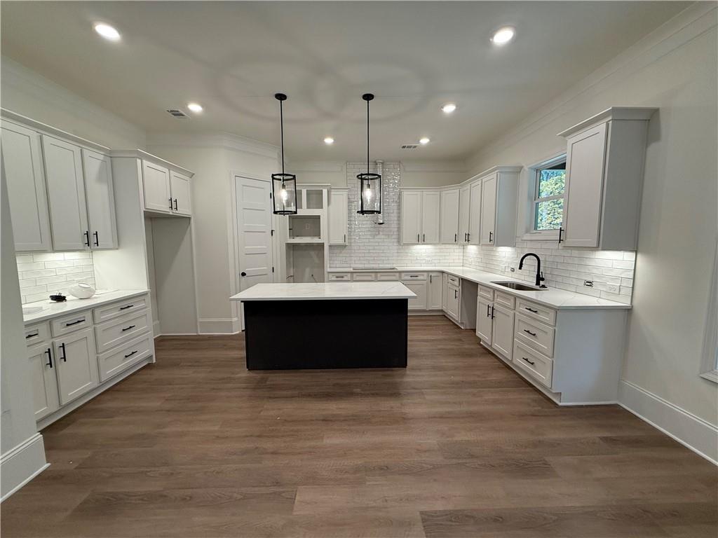 3229 Traditions Way Jefferson, GA 30549 - Photo 14 of 43 a large kitchen with stainless steel appliances kitchen island granite countertop a sink counter space cabinets and a large window