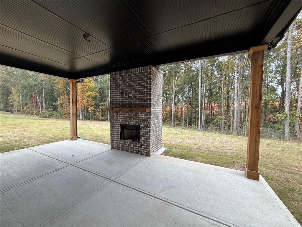 3229 Traditions Way Jefferson, GA 30549 - Photo 40 of 43 a view of an empty room with a fireplace and a large window