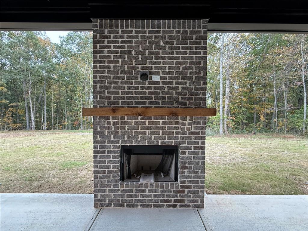 3229 Traditions Way Jefferson, GA 30549 - Photo 41 of 43 a living room with a fireplace and a floor to ceiling window