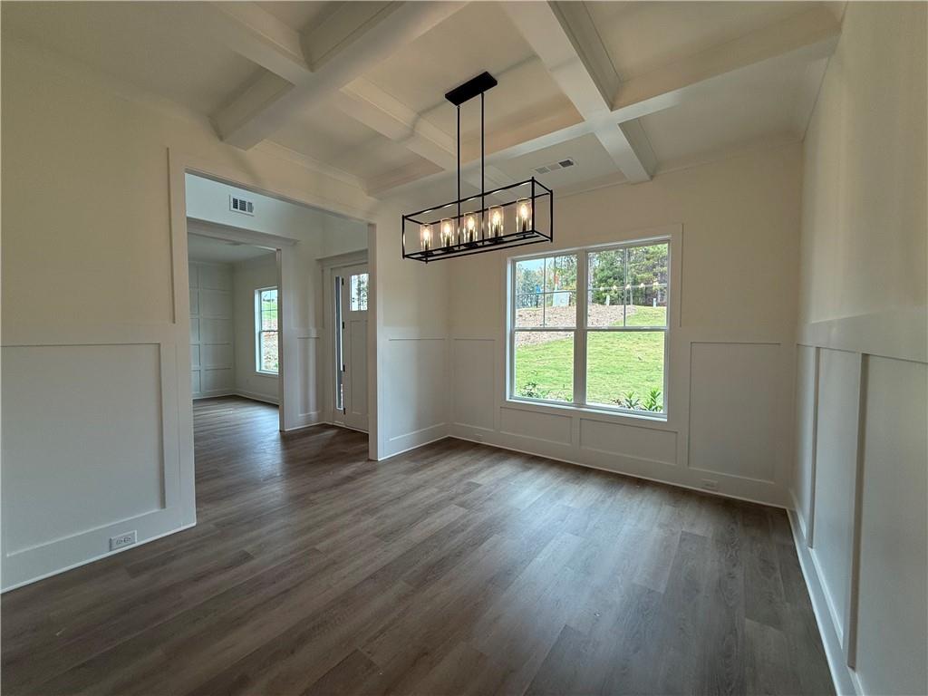 3229 Traditions Way Jefferson, GA 30549 - Photo 7 of 43 an empty room with wooden floor chandelier and windows