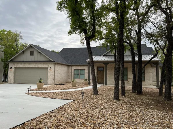 front view of a house with a trees