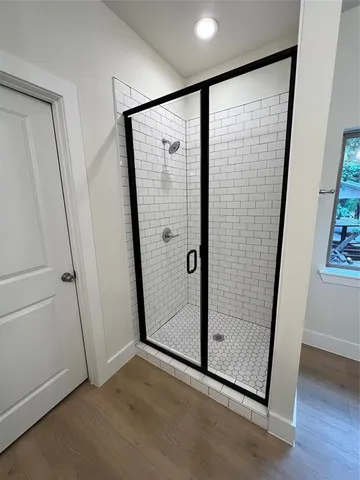 a kitchen with a dining table chairs and a refrigerator