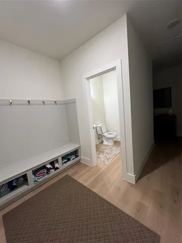 a bathroom with a sink toilet and a mirror