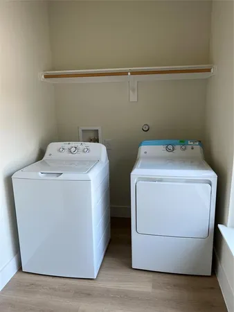 a kitchen with kitchen island stainless steel appliances a stove refrigerator and wooden floor