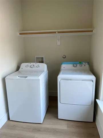 a kitchen with kitchen island stainless steel appliances a stove refrigerator and wooden floor