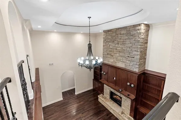 a living room with furniture or chandelier and a wooden floor
