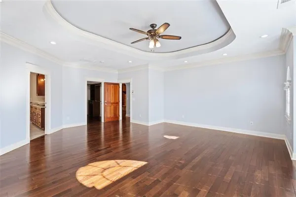 a view of a room with wooden floor and white walls