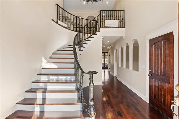 a view of entryway with wooden floor and stairs